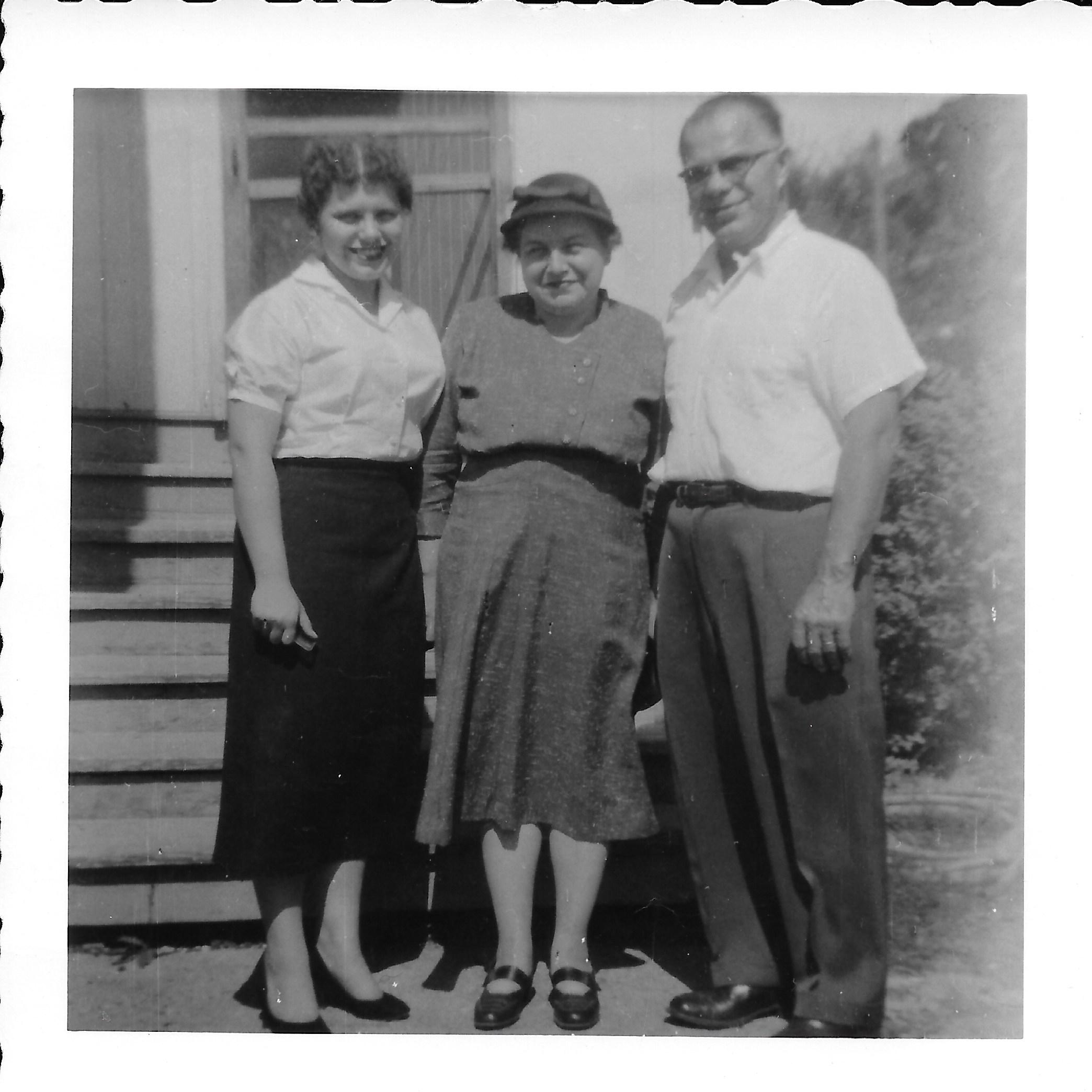 Rita Liberacki, Rachel Wilcox, and Alexander Liberacki outside their back door.